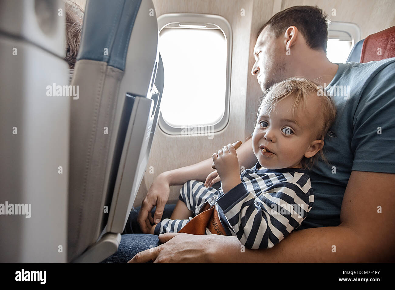 Man with charming infant in plane Stock Photo