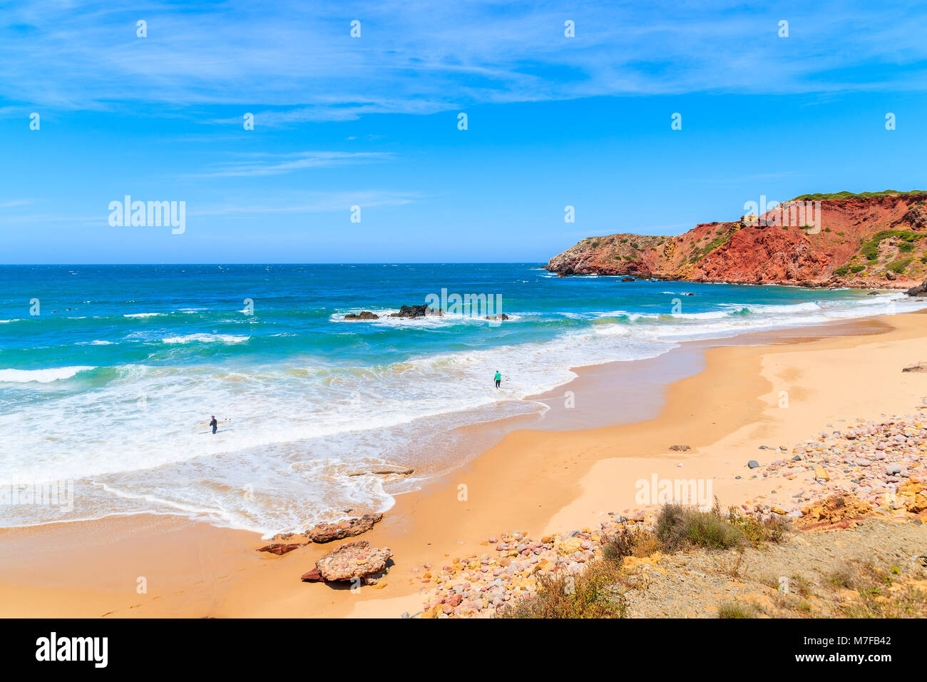 Surfers on Amado beach with big sea waves, Algarve, Portugal Stock Photo