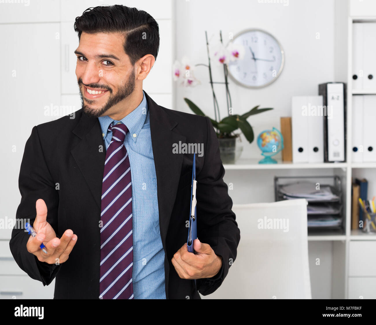 Spanish businessman is talking with partner about contract in office. Stock Photo