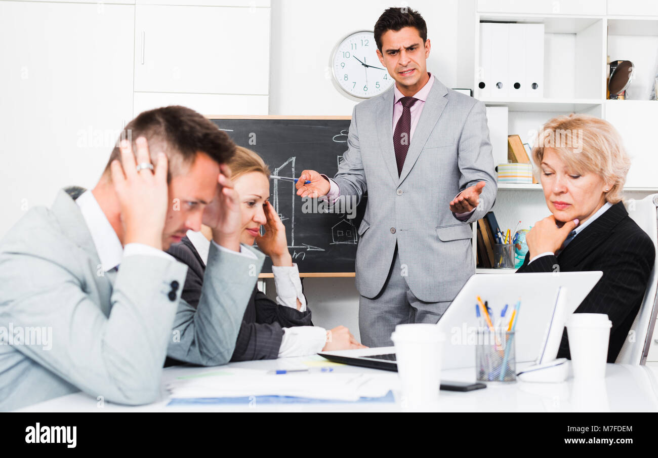 Angry boss blowing up his subordinates for mistakes in work Stock Photo -  Alamy