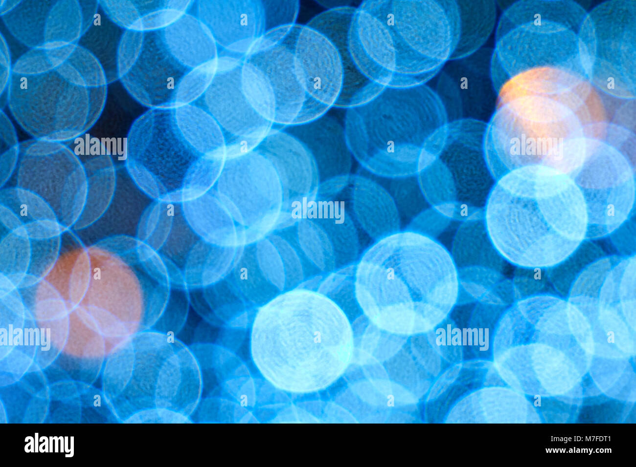 Blue blur background, neon illumination, big bokeh circles with some orange dots texture, pattern Stock Photo