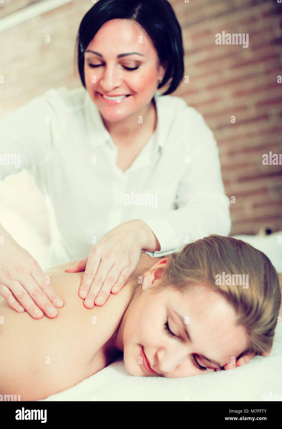 https://c8.alamy.com/comp/M7FFTY/mature-female-massagist-is-doing-relaxing-massage-shoulder-area-for-M7FFTY.jpg