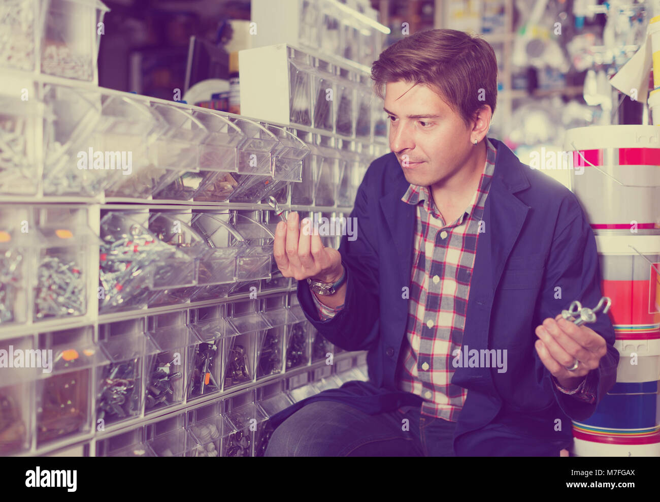 Portrait of american adult customer in hardware store choosing goods