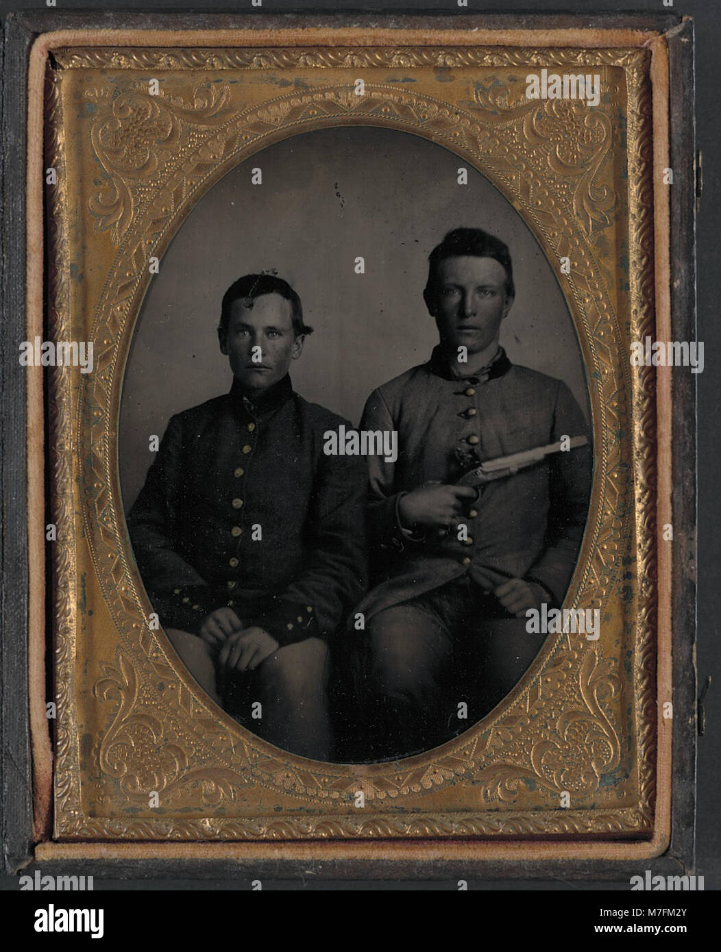 This image features two unidentified soldiers in Confederate uniforms ...