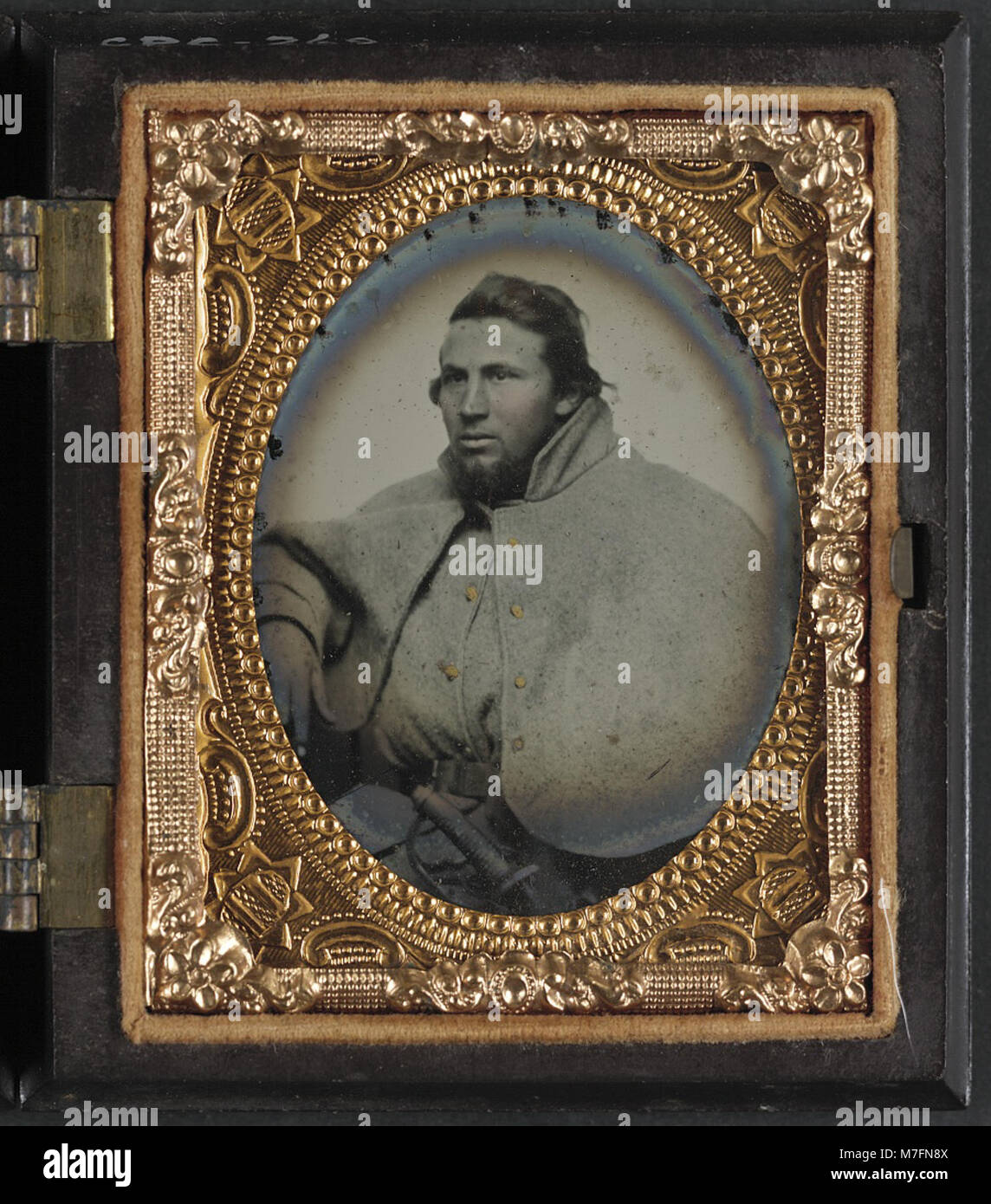 A historical photograph showing an unidentified soldier from the 1st Virginia Cavalry, dressed in a great coat, a piece of military uniform during the Civil War. Stock Photo