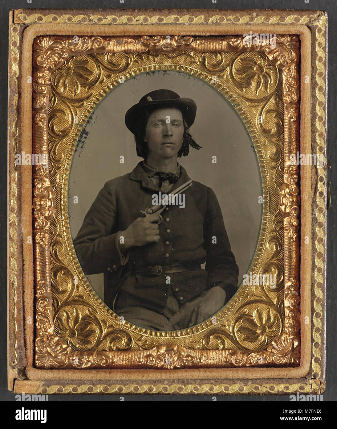 This photograph features an unidentified Confederate soldier, shown in ...