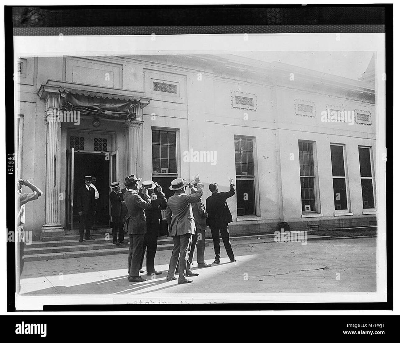 Watching the eclipse of the sun from the executive offices at the White House LCCN2002713125