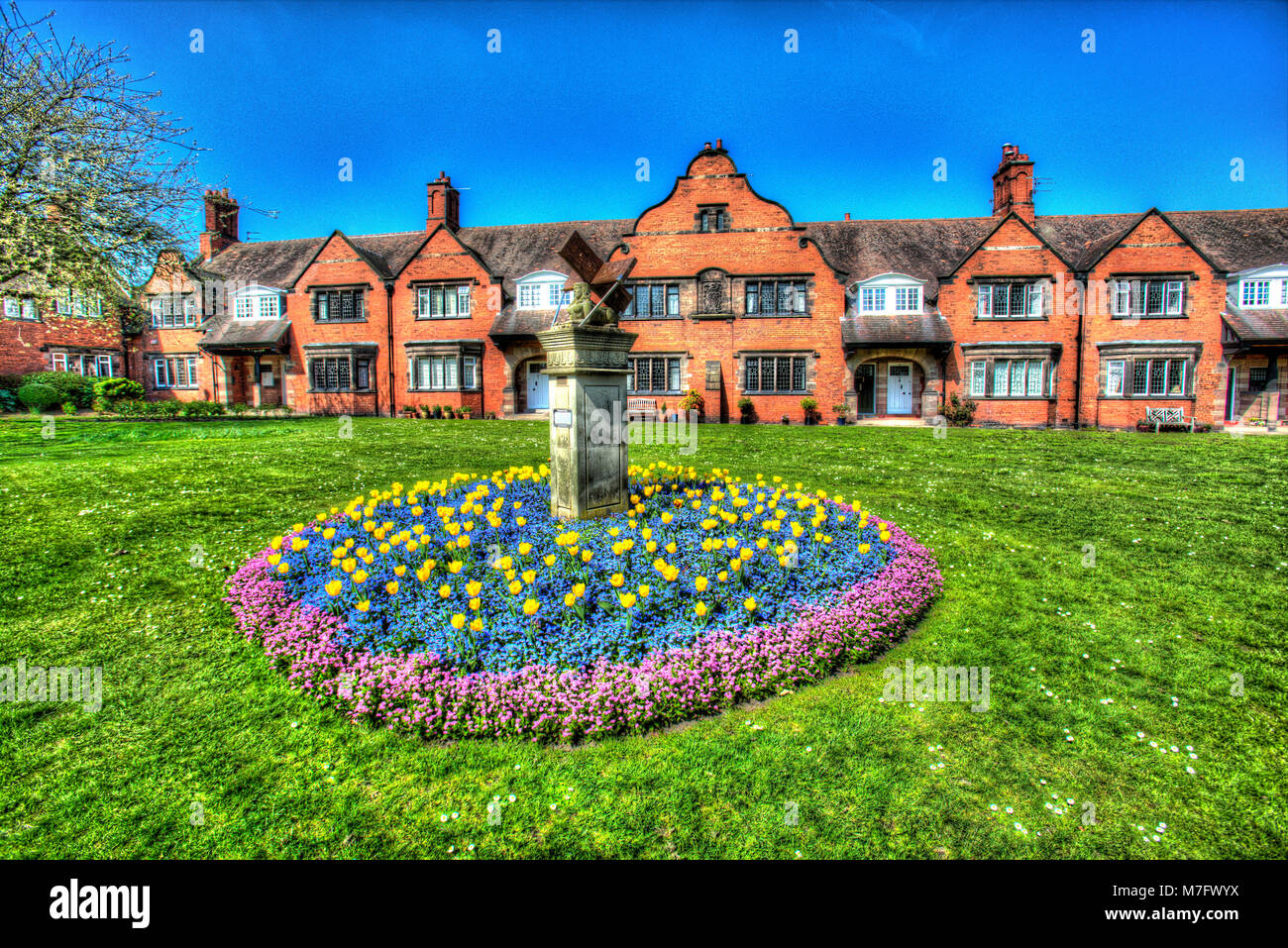 Village of Port Sunlight, England. Artistic view of the New Millennium Sphinx Sundial, with bath Street Cottages in the background. Stock Photo