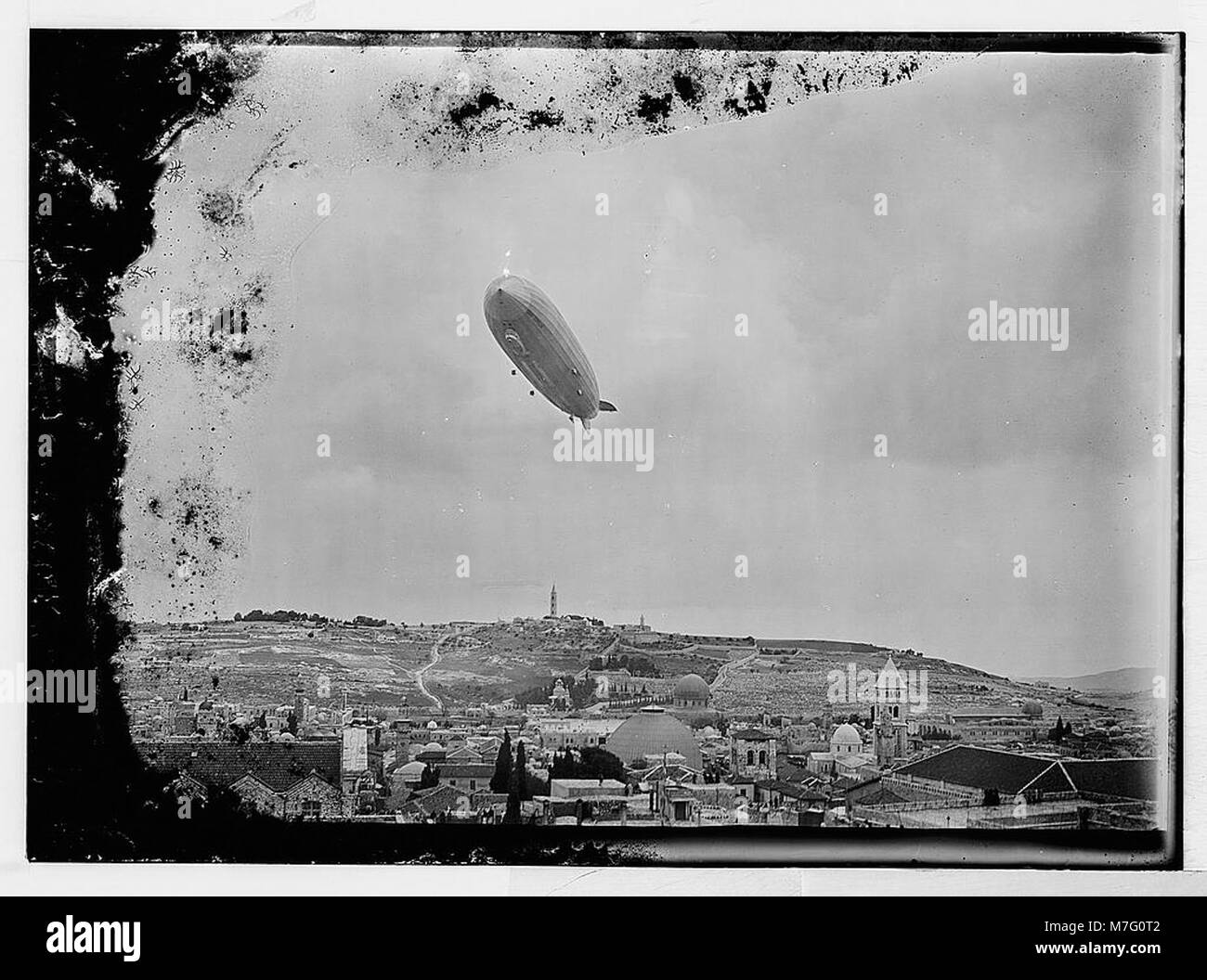A photograph of the Graf Zeppelin flying over Jerusalem, capturing a ...