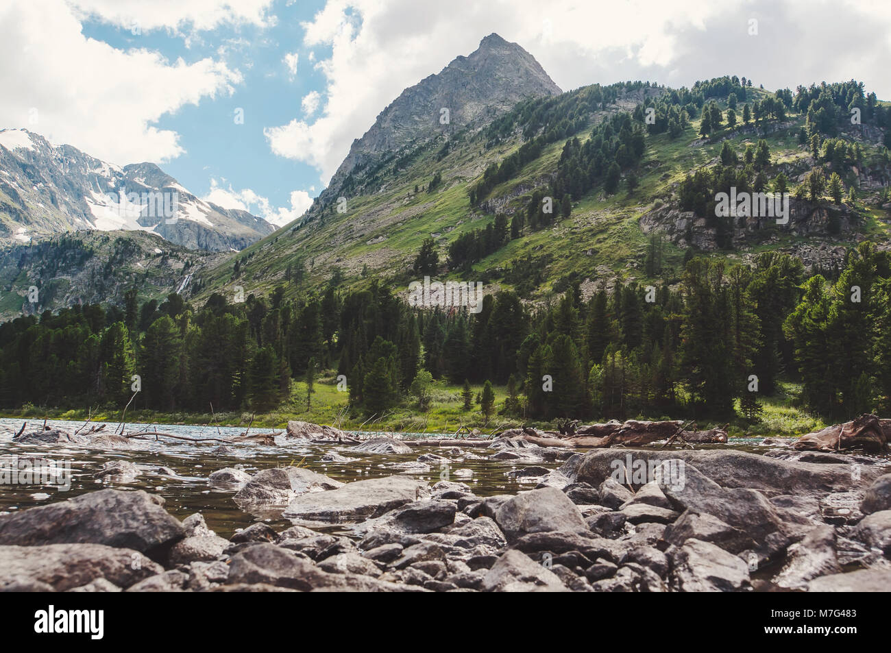 Stones in a mountain lake. The stones in the foreground on a background of mountains and lakes Stock Photo