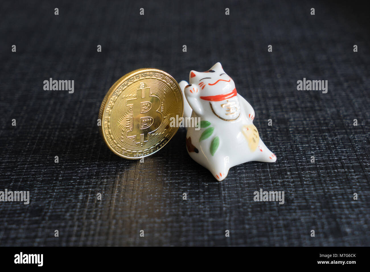 Maneki-neko with bitcoins Stock Photo