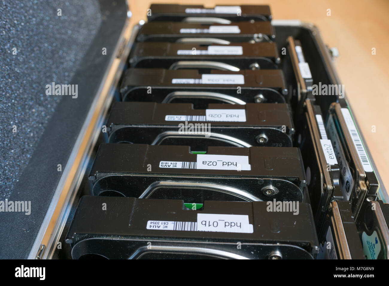 3.5 and 2.5 inch computer backup hard disks in an aluminium storage case. Stock Photo