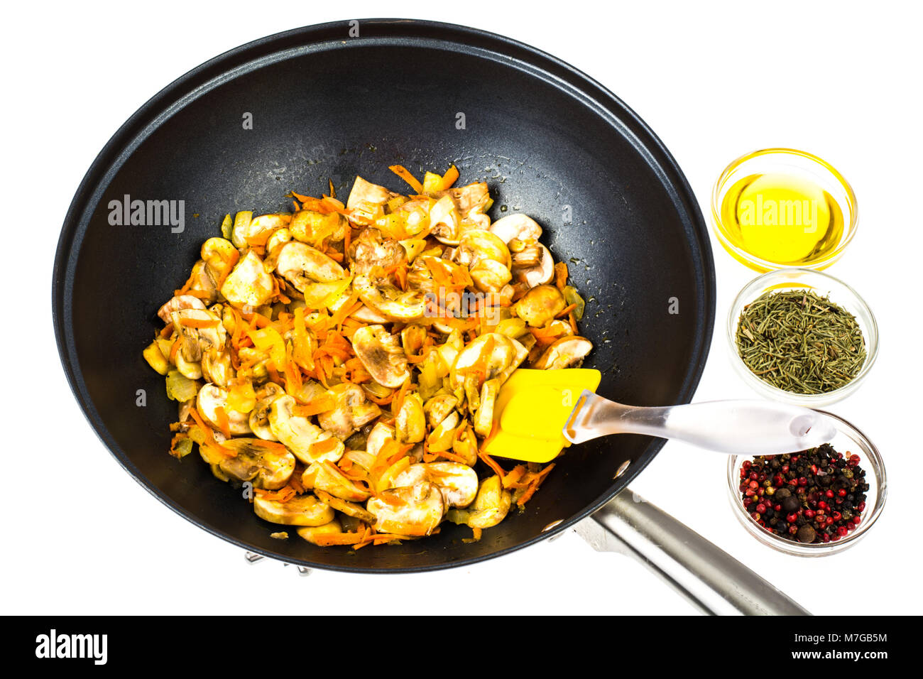 Frying pan wok with fried champignons, onions and carrots Stock Photo