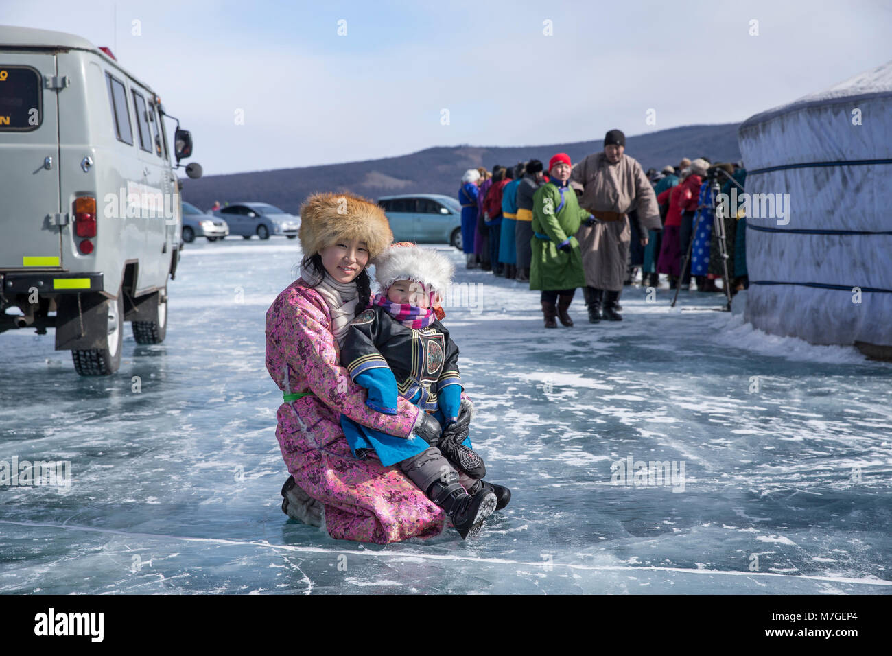 Hatgal, Mongolia, 4th March 2018: mongolian kids dressed in traditional clothing on a frozen lake Khuvsgul Stock Photo