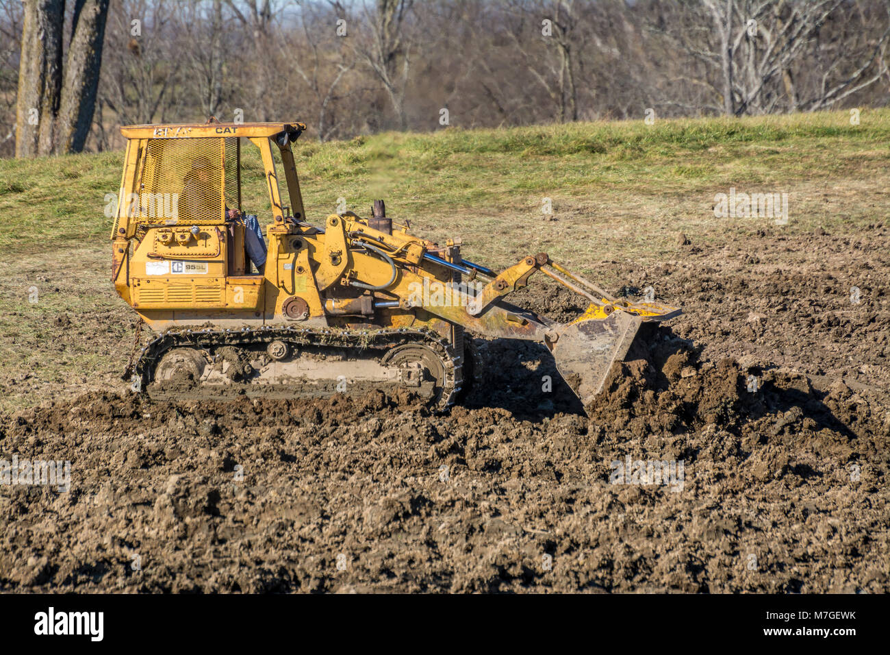 Dozer scoop equipment spreading dirt in a sinkhole in Kentucky USA