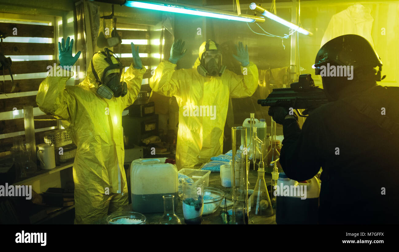 Fully Armed Special Anti-Narcotics Task Forces Soldier Arrests Two Clandestine Chemists Working in the Drug Producing Underground Laboratory. Stock Photo