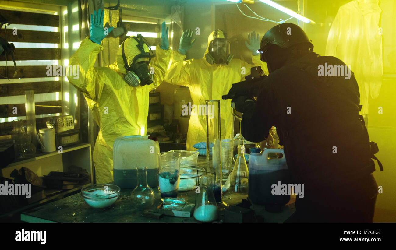 Fully Armed Special Anti-Narcotics Task Forces Soldier Arrests Two Clandestine Chemists Working in the Drug Producing Underground Laboratory. Stock Photo