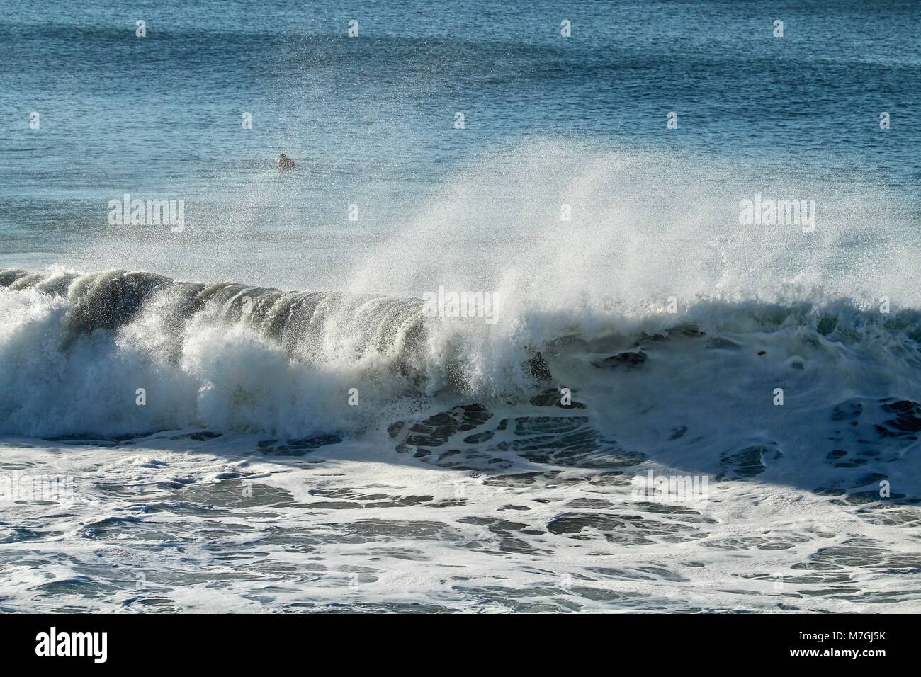 offshore wind waves creating spray Stock Photo
