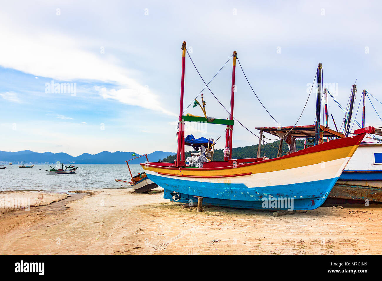 A wooden fishing boat placed in the sand at the costline of Porto Belo, Brazil. Stock Photo