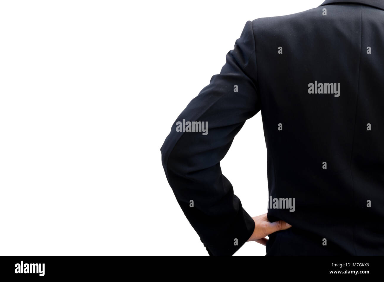 Back side of businessman in dark gray suit standing and akimbo looking forward to be success Stock Photo