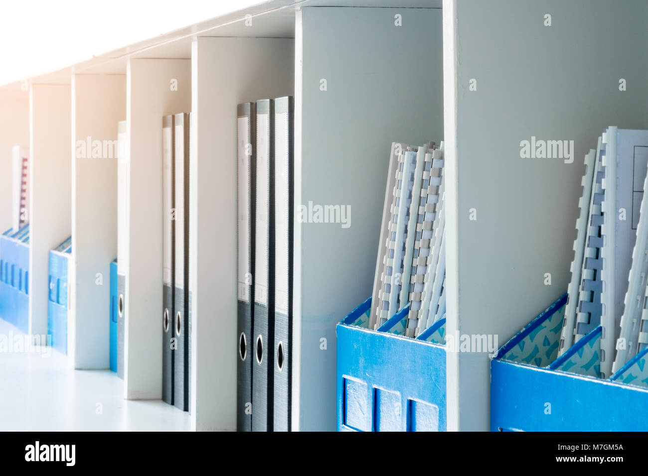 White office document cabinet, shelf and blue document boxes Stock Photo