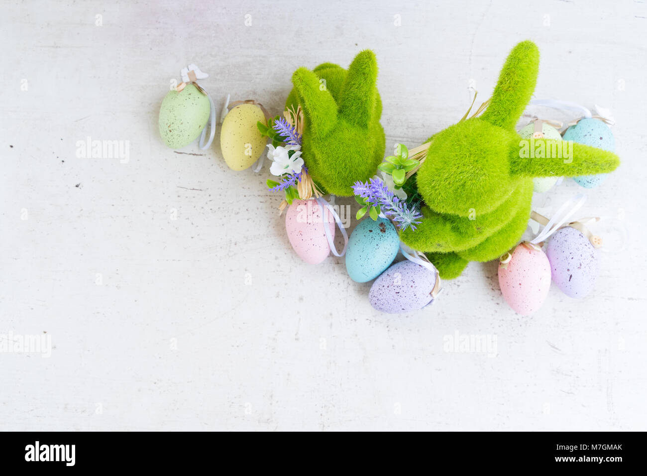 Easter scene with colored eggs and two rabbits Stock Photo - Alamy