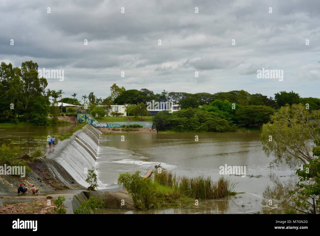 People fishing and mucking around on the weir near Riverview Tavern in Douglas Townsville Queensland Australia Stock Photo