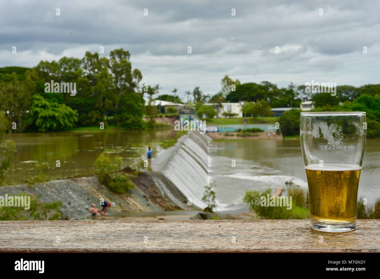 Drinking a beer with views of water overflowing the weir after recent heavy rain, Riverview