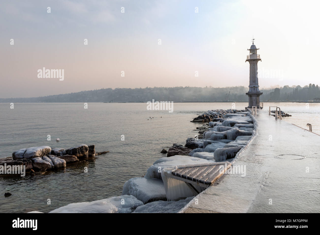 Lighthouse and Bains des Paquis covered in ice, Geneva, Switzerland Stock Photo