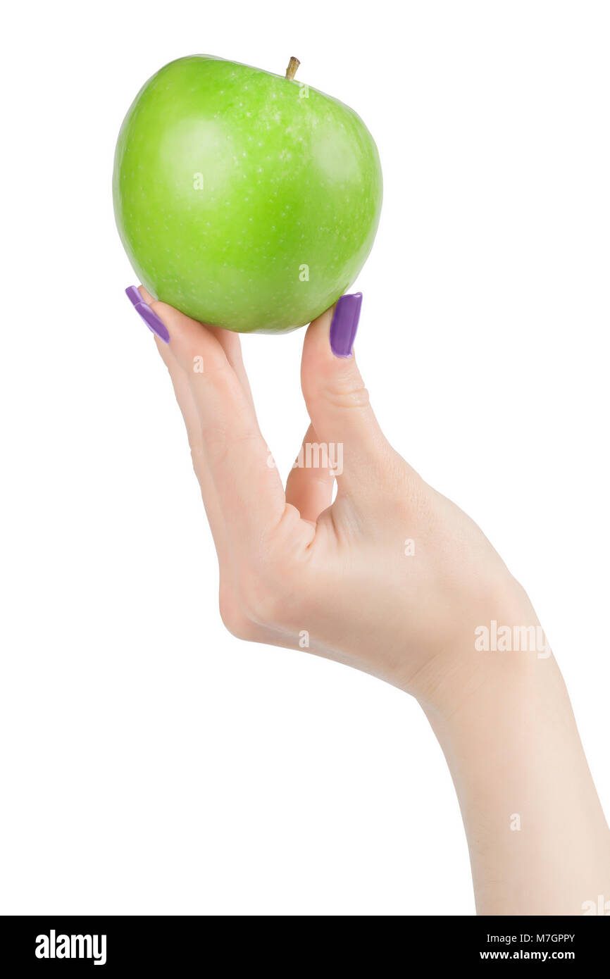 Woman hand with perfect skin and violet nail polish holding bright green apple. Isolated on white, clipping path included Stock Photo
