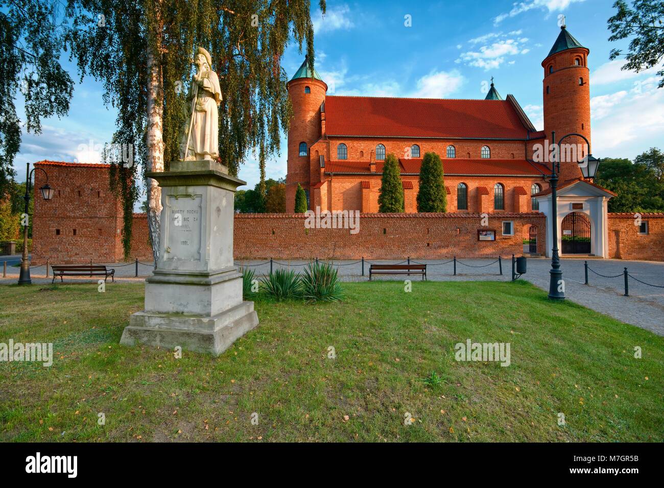 Statue of Saint Roch in front of unique defensive church of Saint Roch ...
