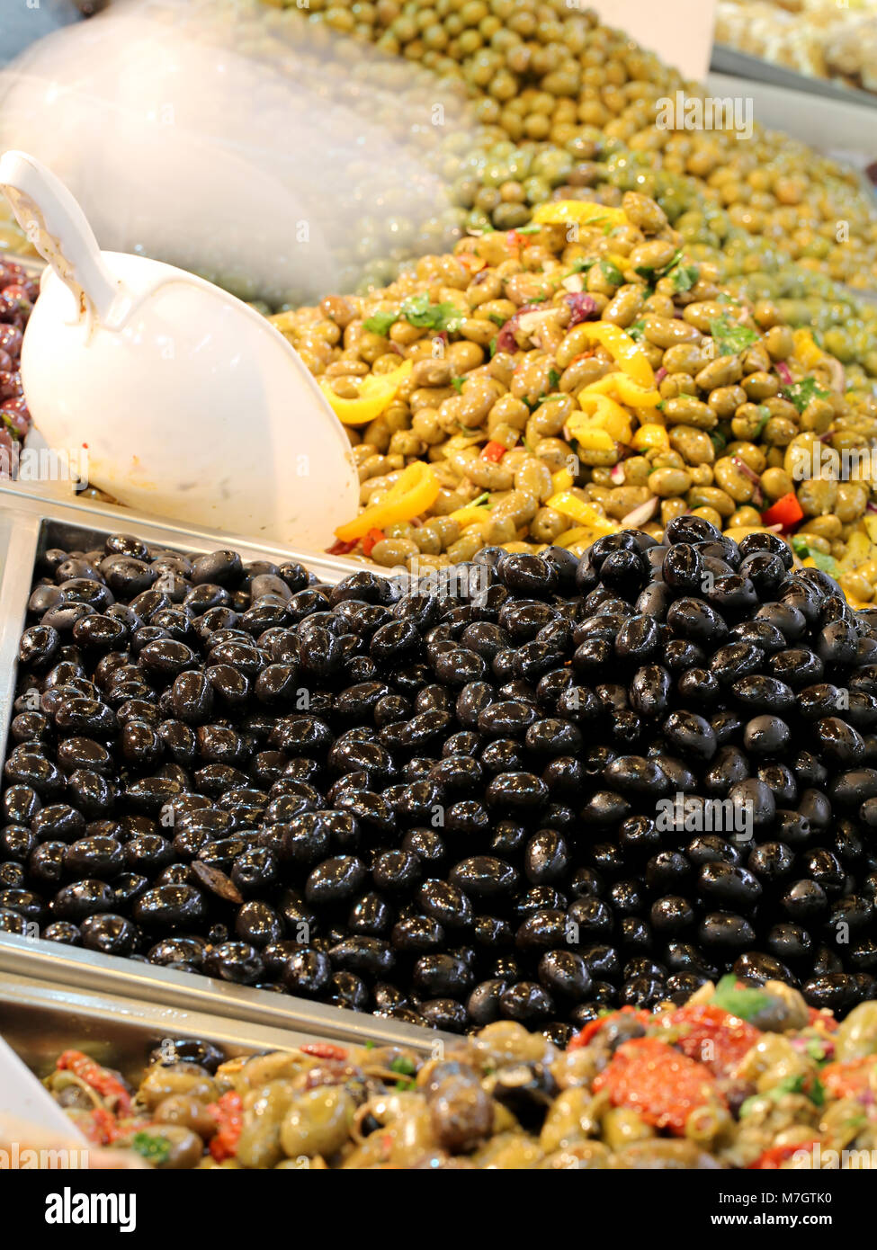 many varieties of fresh olives for sale at the market of the