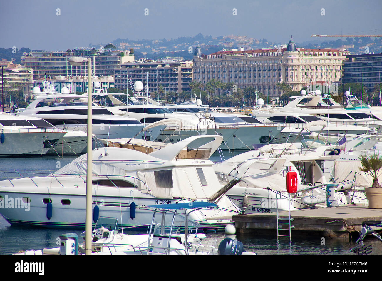 Luxury yachts at marina, at background the luxury hotel 'Hotel Carlton Intercontinental', Cannes, french riviera, South France, France, Europe Stock Photo
