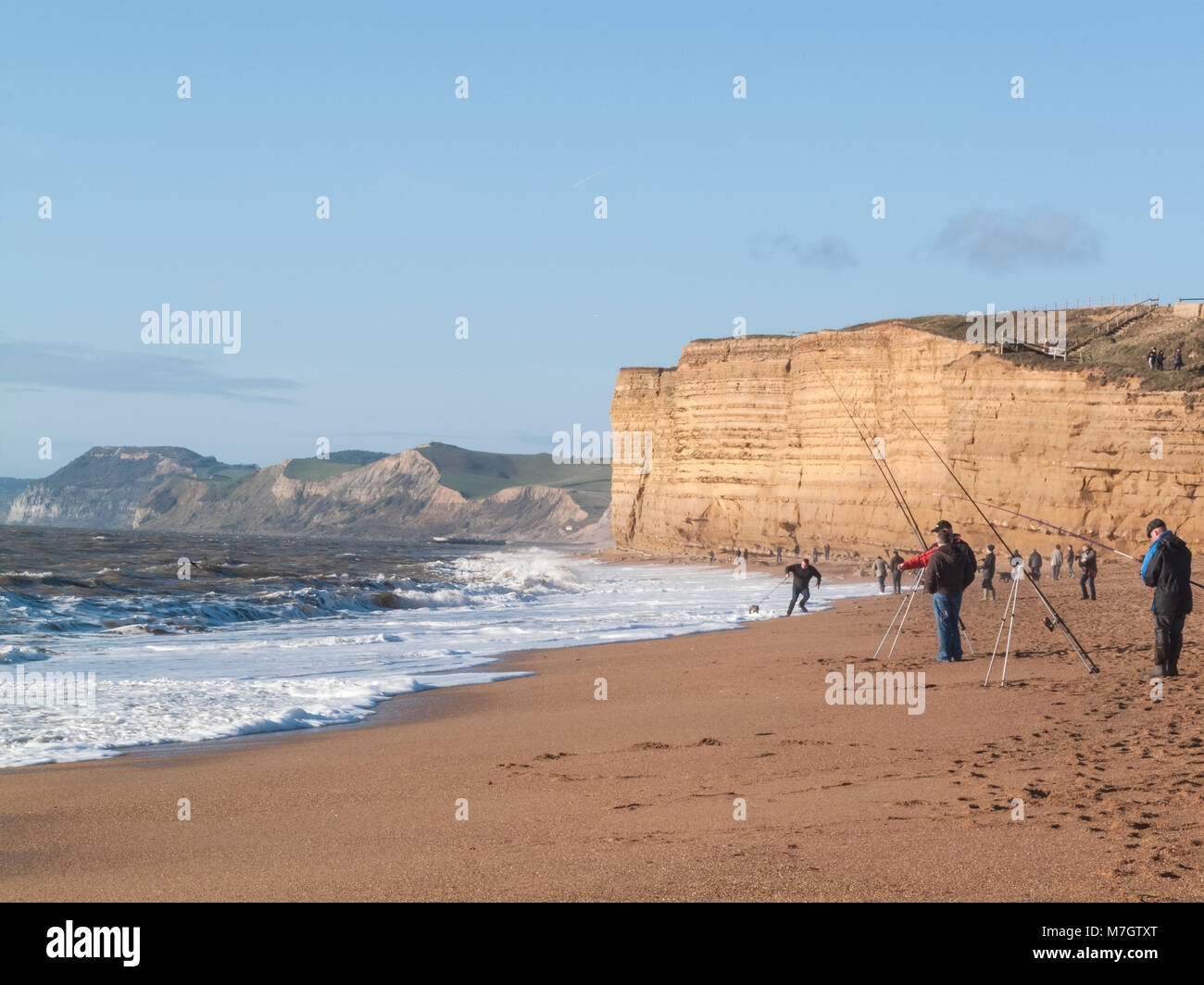 Dog walker caught by the tide Stock Photo