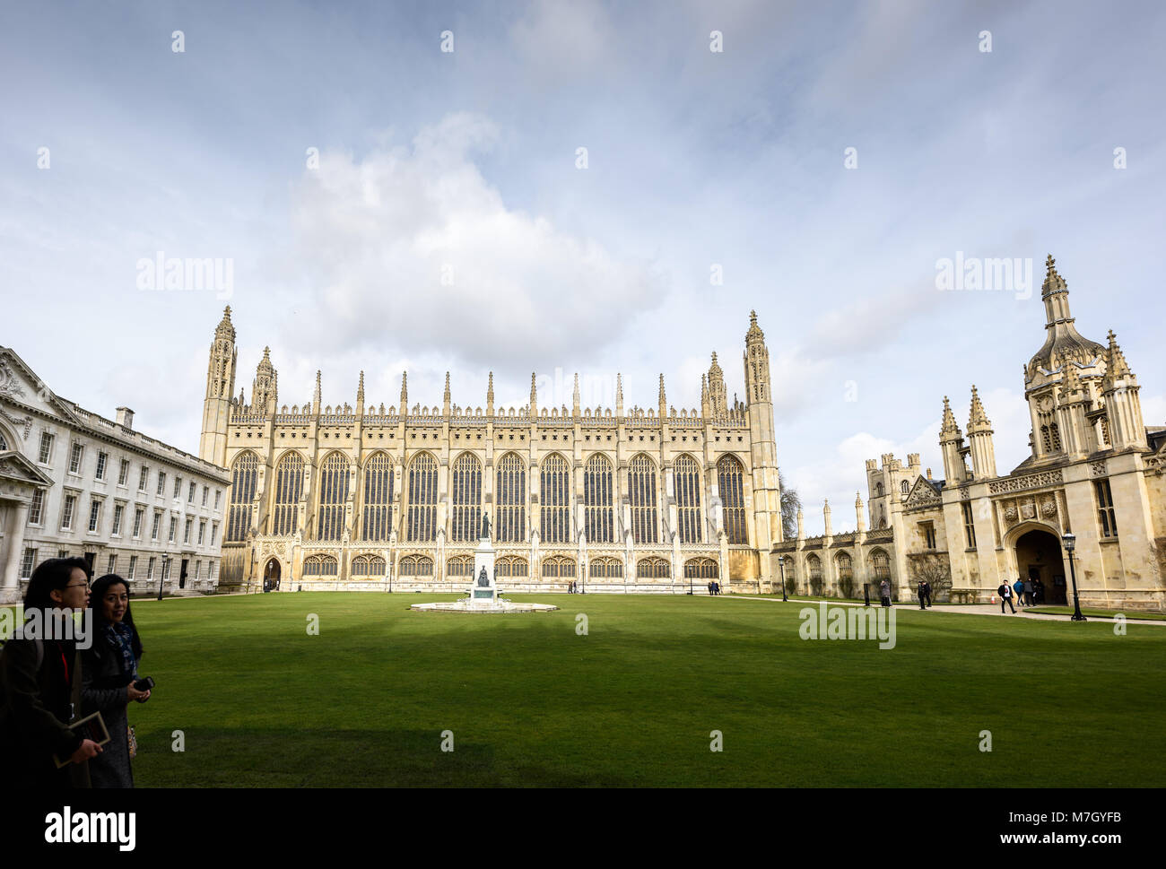 Two female students walk along a path next to the Front Court lawn at King's college, university of Cambridge, England, with the chapel in the centre, Stock Photo