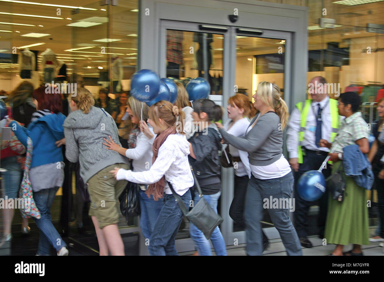 The sales, with young female shoppers queuing and rushing into Primark, Derby, UK Stock Photo