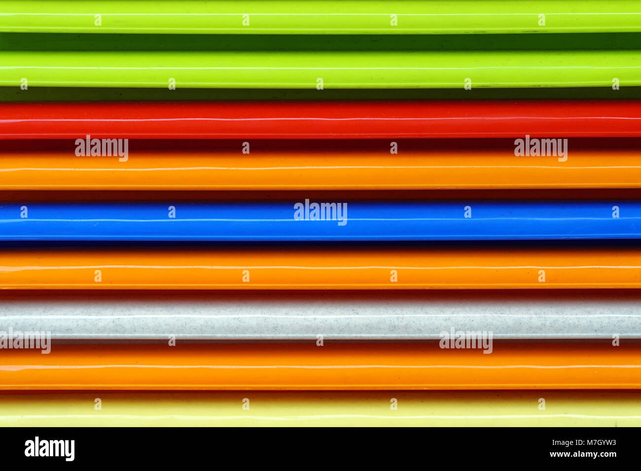 Stacked colorful plastic parts repetitive pattern Stock Photo