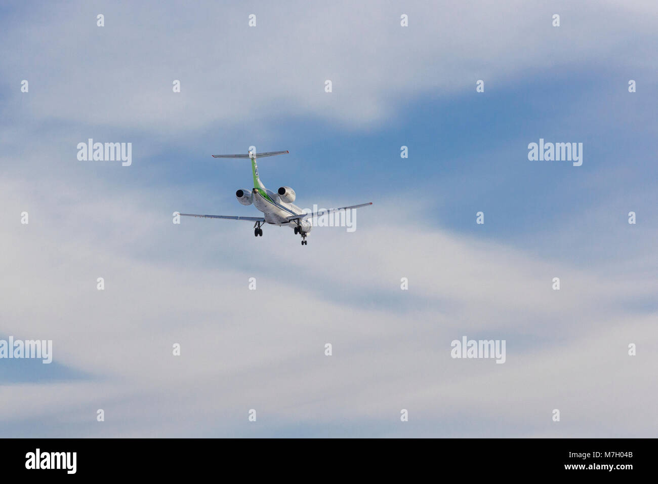 Airplane flies against a background of white clouds Stock Photo - Alamy