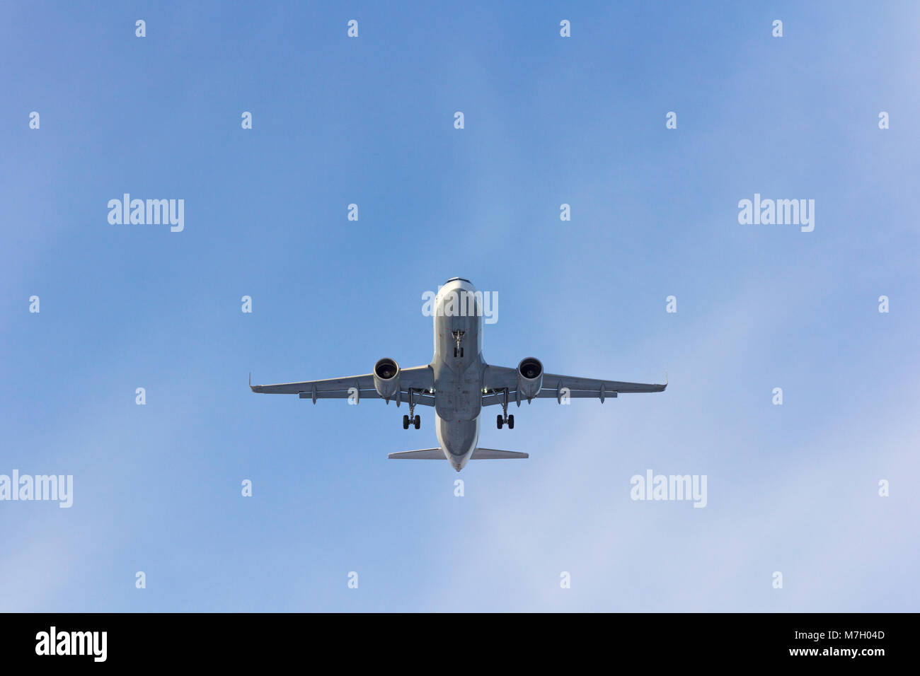 Airplane flies against a background of white clouds Stock Photo - Alamy