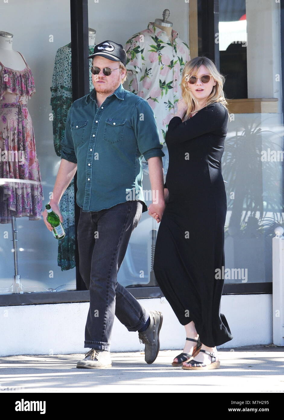 Pregnant Kirsten Dunst shows off her growing baby bump in a tight