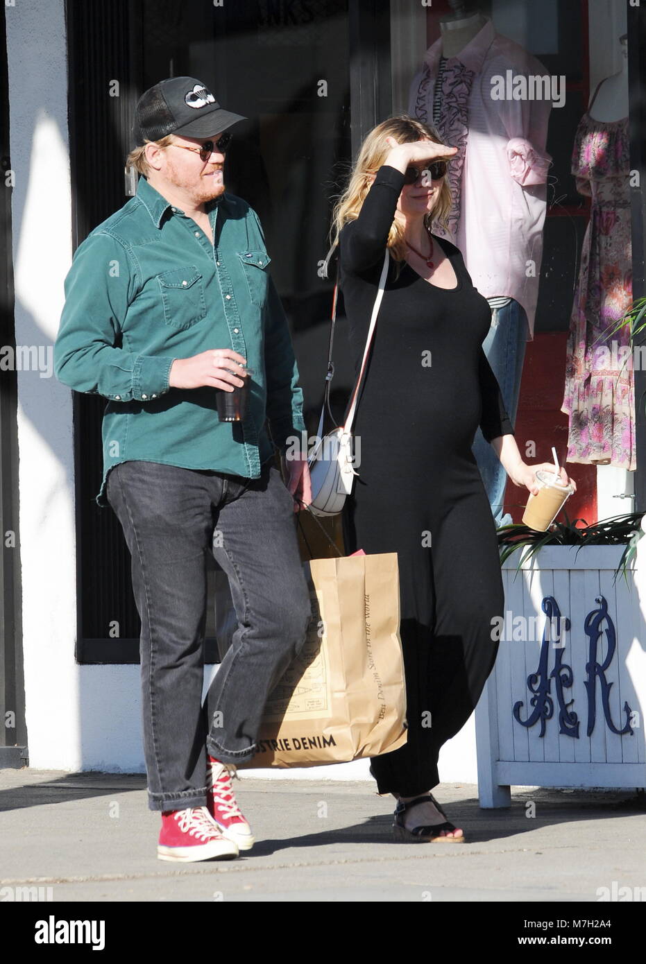 Pregnant Kirsten Dunst shows off her growing baby bump in a tight