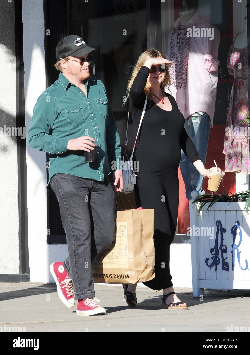 Pregnant Kirsten Dunst shows off her growing baby bump in a tight