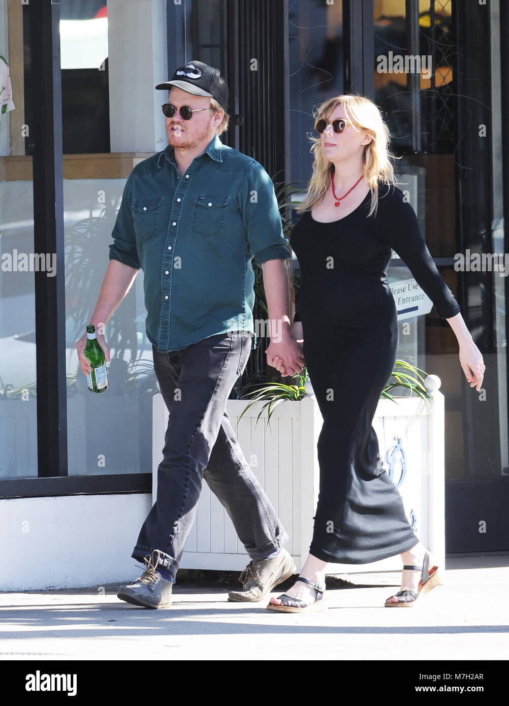 Pregnant Kirsten Dunst shows off her growing baby bump in a tight