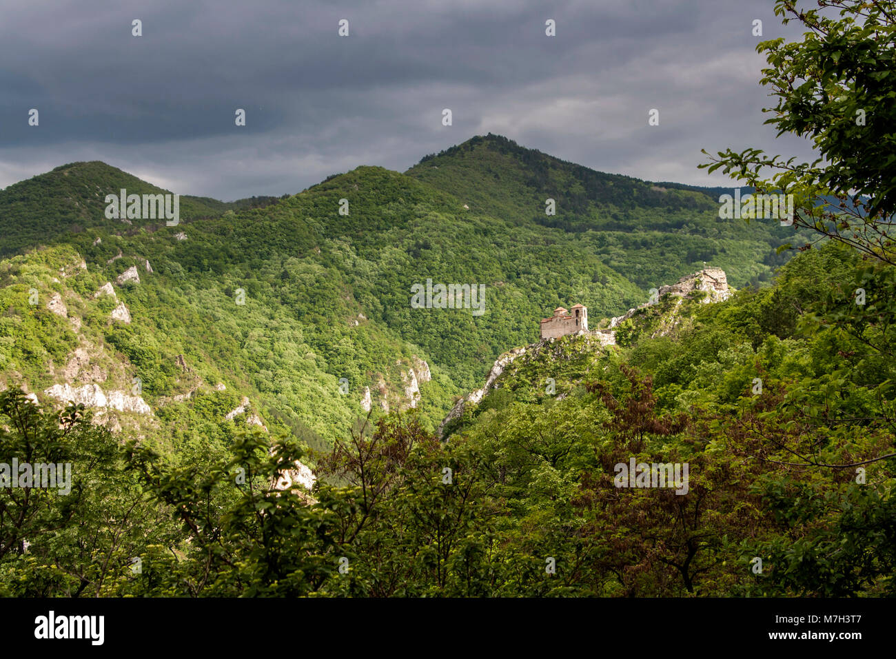 Green landscape during spring with remains of ancient fortress near Assenobgrad in Bulgaria Stock Photo