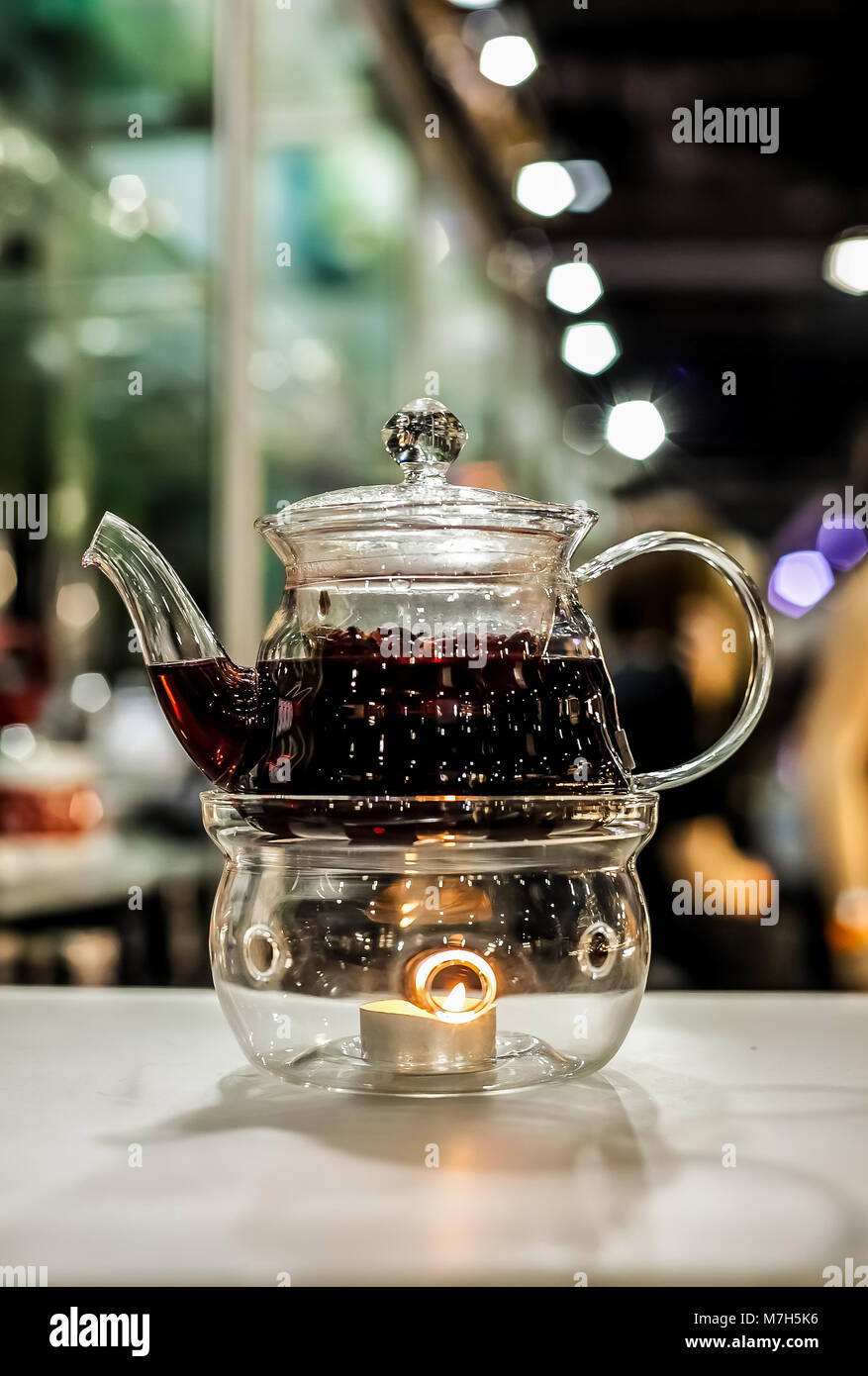 https://c8.alamy.com/comp/M7H5K6/ornate-glass-teapot-with-purple-herbal-tea-infusion-heated-with-a-M7H5K6.jpg