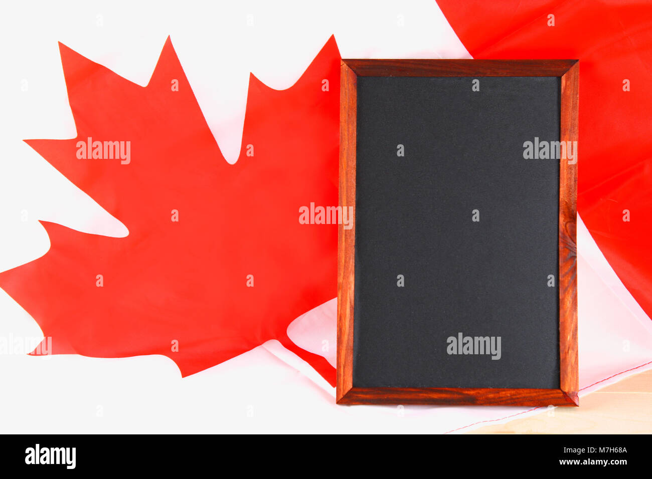 Blackboard with the national flag of Canada drawn on and a chalk Stock