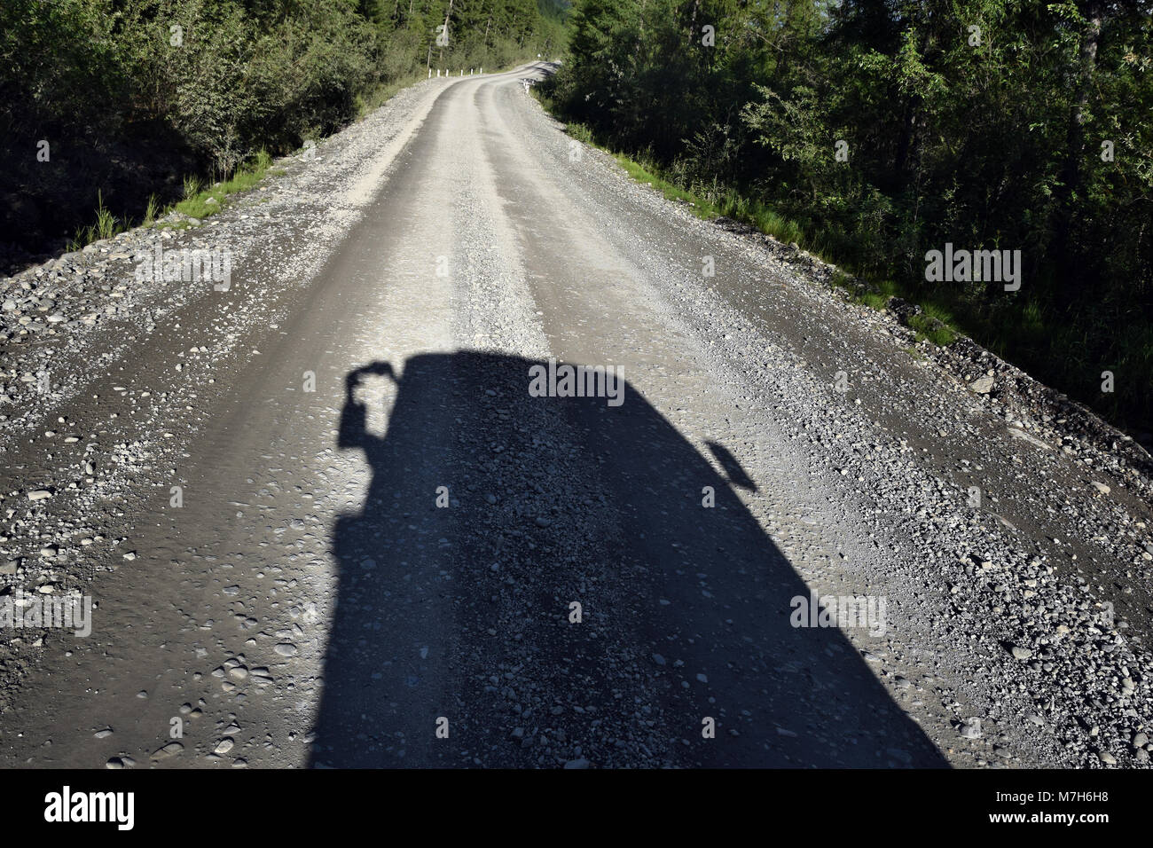The shadow of my van on the Kolyma highway in the Verkhoïansk mountain range. Stock Photo