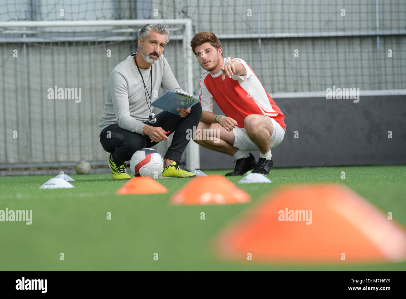 football trainer having a conversation with the player Stock Photo