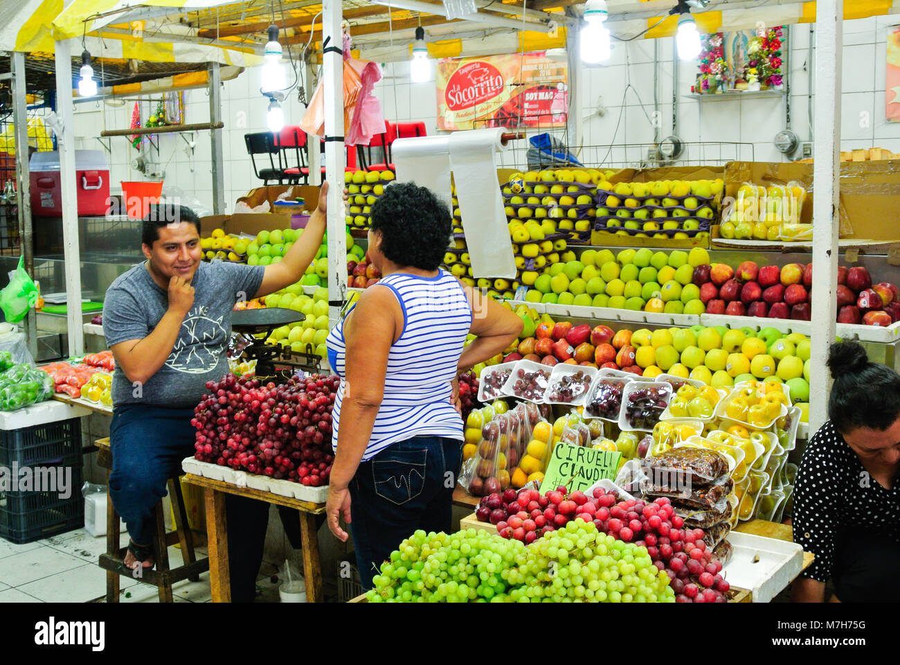 Mexican seller of fruits stand at a local market, Merida, Yucatan, Mexico Stock Photo