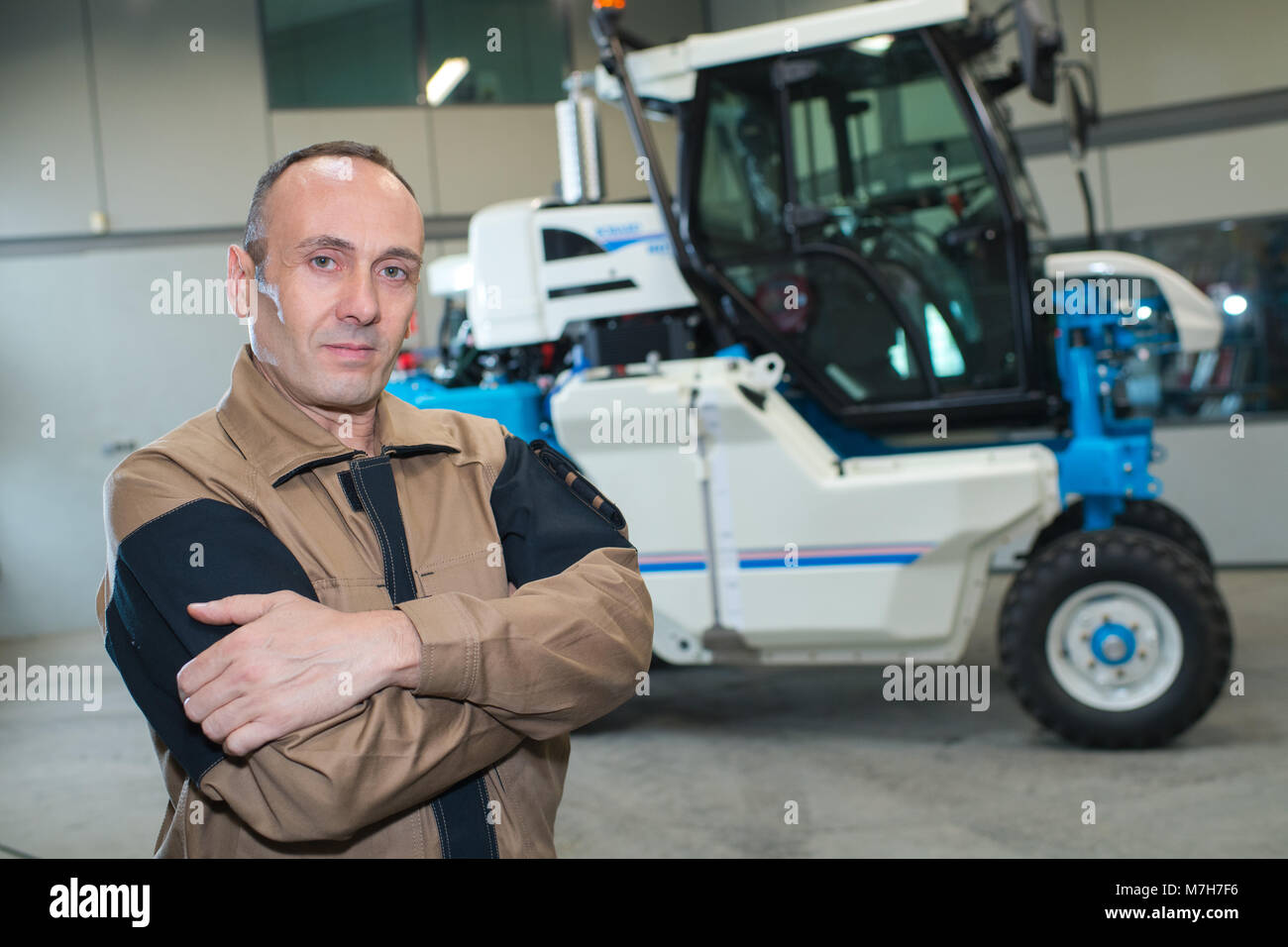 happy farmer next to his tractor Stock Photo - Alamy